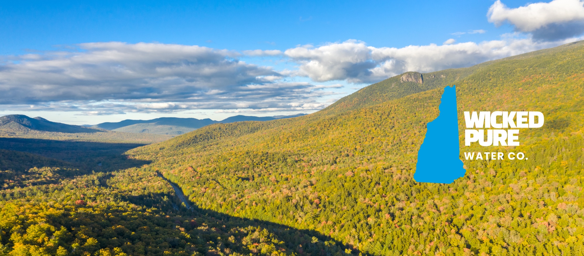 New Hampshire mountains with Wicked Pure Water Co. branding